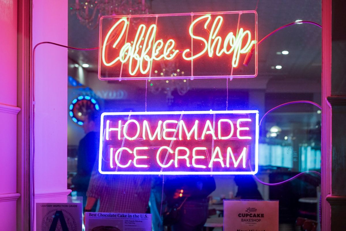 A café's bright neon signage glowing in the window
