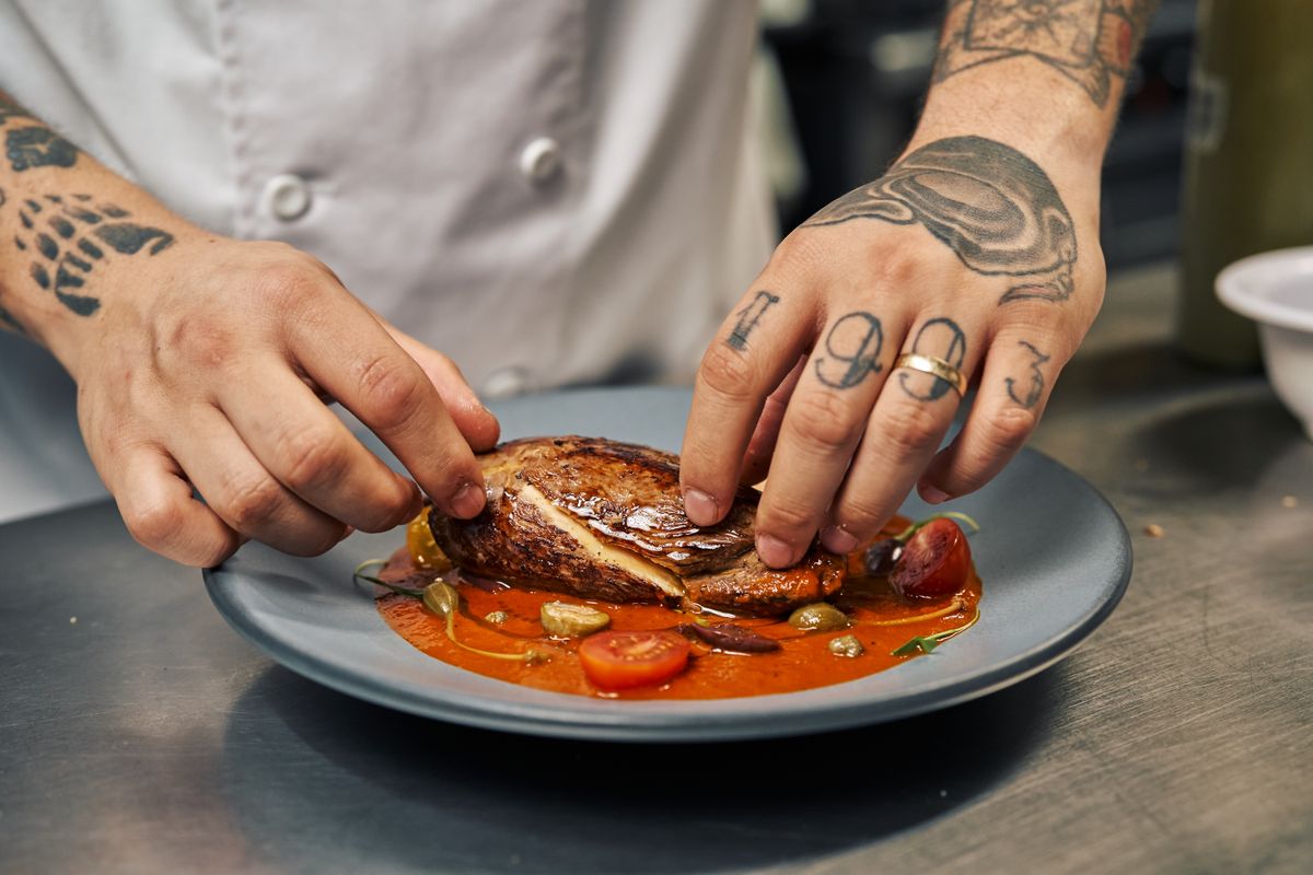 A chef plating a special dish in the kitchen