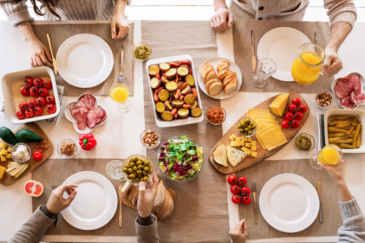 An overhead flat-lay of colourful dishes shot in soft natural window light