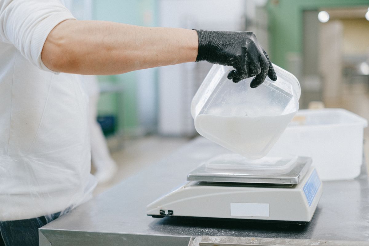Weighing ingredients on a kitchen scale to cost out a recipe